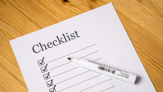 Paper on a table with head that says "Checklist"