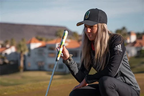 a lifestyle image of a golfer on a green with his putter and Sweetrollz putter grip in hand