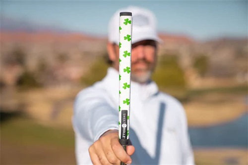 a lifestyle image of a golfer on a green with his putter and Sweetrollz putter grip in hand