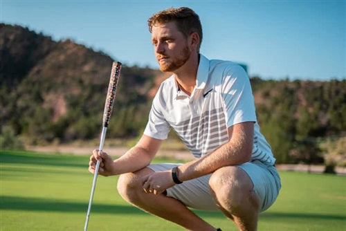 a lifestyle image of a golfer on a green with his putter and Sweetrollz putter grip in hand