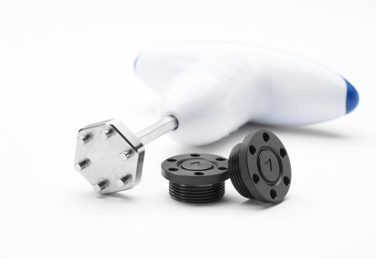 A Mizuno club wrench and putter weights on a white background