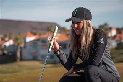 a lifestyle image of a golfer on a green with his putter and Sweetrollz putter grip in hand