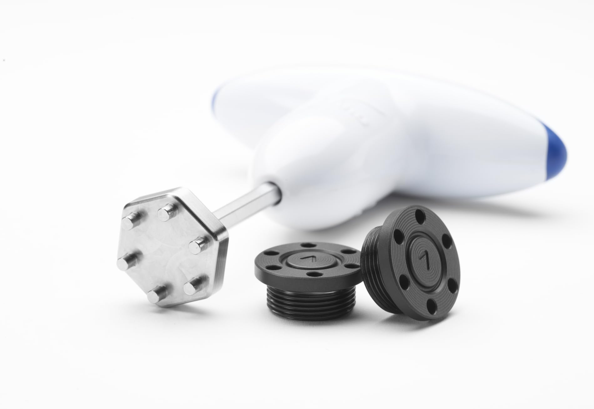 A Mizuno club wrench and putter weights on a white background