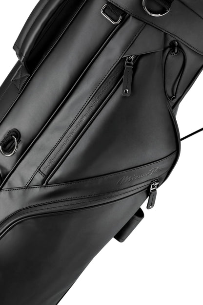 Close-up of a black golf bag with visible branding on a white background