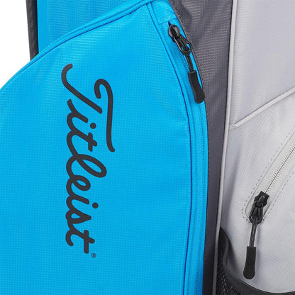 Close-up of a blue golf bag with Titleist logo and gray interior.