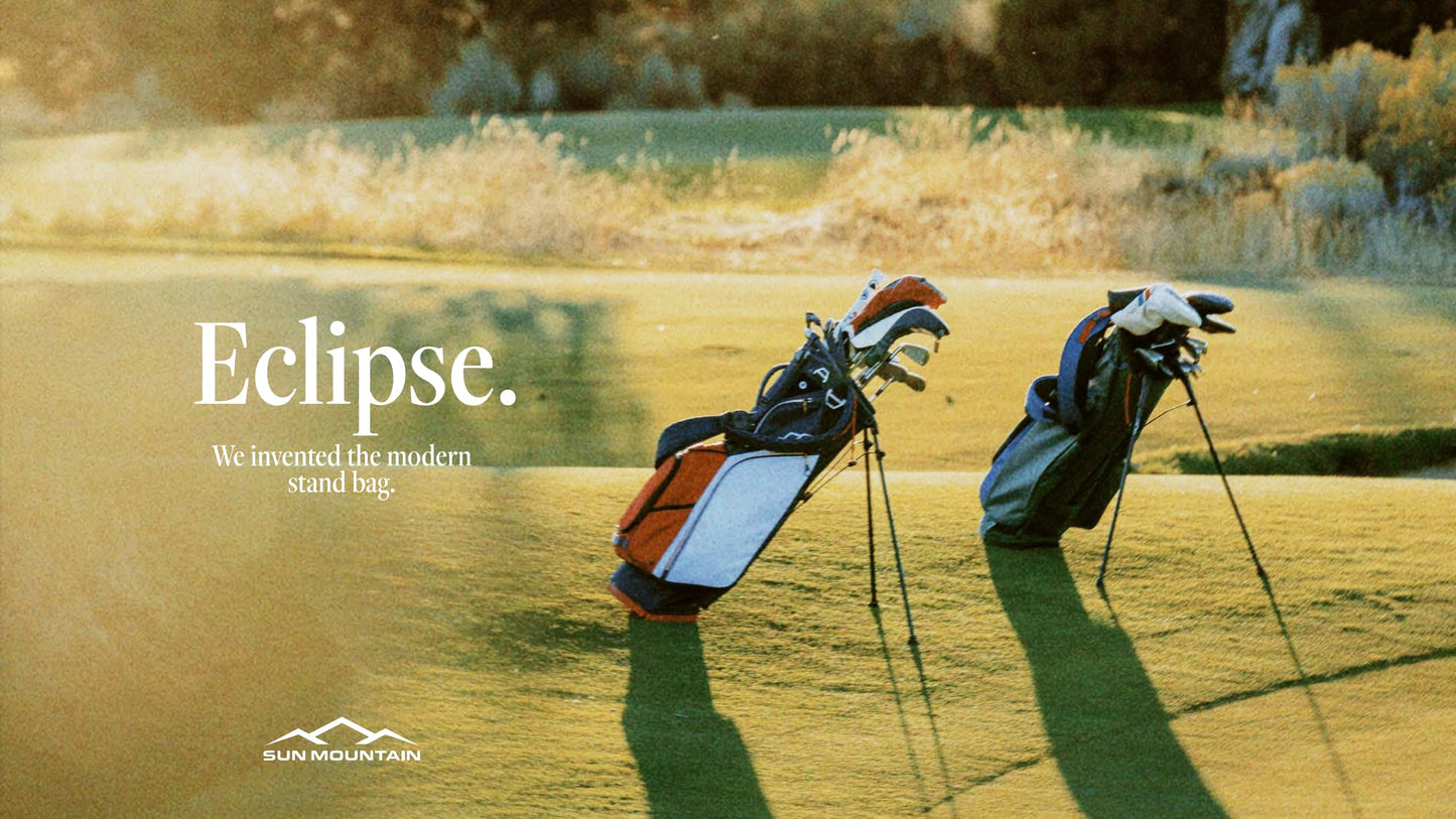 Golf bags on a golf course with 'Eclipse' branding and Sun Mountain logo.