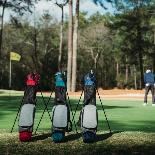 Golf bags on stands with a golfer in the background on a golf course